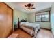 Inviting bedroom with a ceiling fan, wood-look floors, and a closet at 5362 S Danube Ct, Centennial, CO 80015