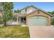 Charming two-story home with a stone-accented garage, porch, and well-maintained lawn at 5362 S Danube Ct, Centennial, CO 80015