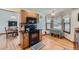 Eat-in kitchen with wood cabinets, black appliances, hardwood floors, a ceiling fan, and a large window at 5362 S Danube Ct, Centennial, CO 80015
