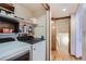Convenient laundry room with washer, dryer, storage shelves, and access to stairs at 5362 S Danube Ct, Centennial, CO 80015