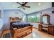 Main bedroom featuring a beautiful bed, hardwood floors, vaulted ceilings, and natural light at 5362 S Danube Ct, Centennial, CO 80015