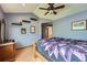 Main bedroom features hardwood floors, a ceiling fan, vaulted ceilings, and wall decor at 5362 S Danube Ct, Centennial, CO 80015