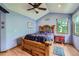Main bedroom features hardwood floors, a ceiling fan, and natural light at 5362 S Danube Ct, Centennial, CO 80015