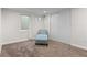 Bright bedroom with a comfortable chair, natural light, and ample closet space for storage and organization at 3117 Victor St, Aurora, CO 80011
