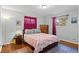 Cozy bedroom with hardwood floors, comfortable bed, and ample natural light at 3117 Victor St, Aurora, CO 80011