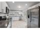 Bright kitchen featuring stainless steel appliances, white cabinets, and a modern tiled backsplash at 3117 Victor St, Aurora, CO 80011
