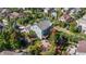 Aerial view of backyard with stone patio, built-in fire pit, landscaping, and a wooden deck off of the home at 1519 Stonehill Ct, Castle Rock, CO 80104