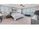 Bright bedroom featuring three windows, a bed and views of trees and sky at 1519 Stonehill Ct, Castle Rock, CO 80104