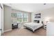 Bright bedroom featuring two windows, a bed, desk, and neutral walls and carpet at 1519 Stonehill Ct, Castle Rock, CO 80104