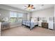 Bedroom with a ceiling fan, two windows, a bed, and two desks at 1519 Stonehill Ct, Castle Rock, CO 80104