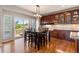 Elegant dining area featuring wood floors, built-in cabinets, and deck access at 1519 Stonehill Ct, Castle Rock, CO 80104