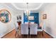 Elegant dining room with hardwood floors, tray ceiling, and modern chandelier at 1519 Stonehill Ct, Castle Rock, CO 80104