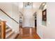 Inviting foyer with hardwood floors, soaring ceilings, and elegant staircase at 1519 Stonehill Ct, Castle Rock, CO 80104