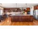 Spacious kitchen with dark wood cabinets, a large island, and stainless steel appliances at 1519 Stonehill Ct, Castle Rock, CO 80104