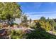 Landscaping features beautiful shrubs and trees, enhancing the property's curb appeal at 1519 Stonehill Ct, Castle Rock, CO 80104