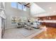 Bright and airy living room with large windows, and a seamless transition to the kitchen at 1519 Stonehill Ct, Castle Rock, CO 80104