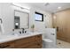 Well lit bathroom featuring stylish vanity, modern fixtures, and a glass-enclosed shower stall at 1544 S Fillmore St, Denver, CO 80210