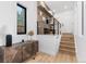 Bright entryway features a custom cabinet, shelving, and staircase with modern railings at 1544 S Fillmore St, Denver, CO 80210