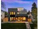 Modern two-story home with black brick, a front patio, and steps leading to a grassy lawn at 1544 S Fillmore St, Denver, CO 80210