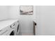 Bright laundry room featuring a white washer and dryer with neutral walls and a decorative art piece at 1544 S Fillmore St, Denver, CO 80210