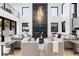 Bright and airy living room boasts a modern fireplace, soaring ceilings, and ample seating for entertaining at 1544 S Fillmore St, Denver, CO 80210