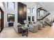Open-concept living room with a modern fireplace and staircase at 1544 S Fillmore St, Denver, CO 80210