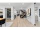 Open-concept living space with a kitchen, dining area, floating staircase, and wood flooring at 1544 S Fillmore St, Denver, CO 80210
