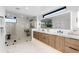 Modern bathroom featuring a double vanity, a large shower, and wood-look cabinets at 1544 S Fillmore St, Denver, CO 80210