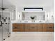 Modern bathroom featuring a double vanity, a large shower, and wood-look cabinets at 1544 S Fillmore St, Denver, CO 80210