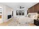 Bright main bedroom boasting a fireplace, ceiling fan, light floors, and large windows at 1544 S Fillmore St, Denver, CO 80210