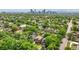 Aerial view of neighborhood showcasing mature trees and the city skyline in the distance at 2849 N Vine St, Denver, CO 80205