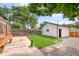 Backyard featuring a white detached garage with a small yard and concrete patio at 2849 N Vine St, Denver, CO 80205