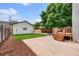 Backyard with concrete patio, small deck, new green lawn, and detached garage at 2849 N Vine St, Denver, CO 80205