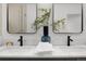 Well-lit bathroom vanity with double sinks, modern faucets, a plant, and a white marble countertop at 2849 N Vine St, Denver, CO 80205
