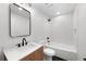 Modern bathroom with black fixtures, white subway tile, and wood-look vanity at 2849 N Vine St, Denver, CO 80205