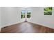 Corner bedroom with ample natural light and wood-look flooring at 2849 N Vine St, Denver, CO 80205