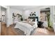 Stylishly decorated bedroom with hardwood floors, large windows, plants, and modern decor at 2849 N Vine St, Denver, CO 80205