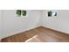 Bright, airy bedroom with hardwood floors, white walls, and ample natural light from two windows at 2849 N Vine St, Denver, CO 80205