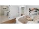 Comfortable bedroom with hardwood floors, a view into the bathroom, and modern furnishings at 2849 N Vine St, Denver, CO 80205