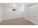 Cozy carpeted basement bedroom with good natural light and closet space at 2849 N Vine St, Denver, CO 80205