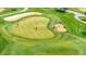 Aerial view of golf course with golfers, sand traps, and green grass at 2849 N Vine St, Denver, CO 80205