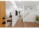 Bright hallway featuring wood floors, white walls, and a staircase with white banisters at 2849 N Vine St, Denver, CO 80205