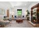 Bright and stylish living room with modern furnishings, fireplace, and large window overlooking lush greenery at 2849 N Vine St, Denver, CO 80205