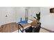 Stylish home office featuring a unique chair, wood floors, and white walls at 2849 N Vine St, Denver, CO 80205