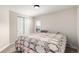 Bright bedroom featuring a cozy bed, closet space, and natural light from the window for a comfortable retreat at 5865 E Ithaca Pl, Denver, CO 80237