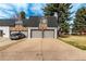 Charming townhome featuring a two-car garage, brick accents, and a well-maintained driveway in a residential neighborhood at 5865 E Ithaca Pl, Denver, CO 80237