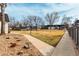 Well-maintained front yard with mature trees and landscaping near a sidewalk and buildings at 5865 E Ithaca Pl, Denver, CO 80237
