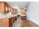 Updated kitchen with stainless steel appliances, granite countertops, and cherry wood cabinets for a modern look at 5865 E Ithaca Pl, Denver, CO 80237
