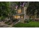 Charming townhome featuring stone accents, red shutters, and a well-maintained front yard with mature trees at 9519 W Coal Mine Ave # F, Littleton, CO 80123