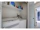 A tidy laundry area with modern washer and dryer, and convenient shelving at 9519 W Coal Mine Ave # F, Littleton, CO 80123